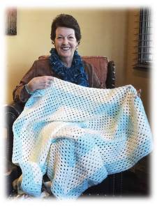 Ann Nease displays one of the many baby blankets she has crocheted for the upcoming baby shower for the National Guard.